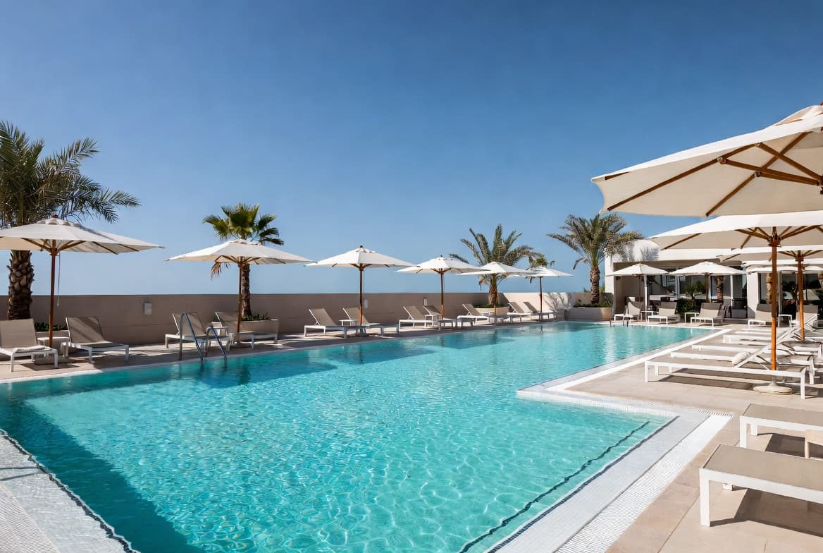 Swim club pool deck and cabana area on a bright summer day